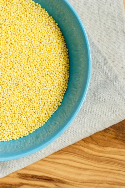 Millet groats in blue bowl — Stock Photo, Image