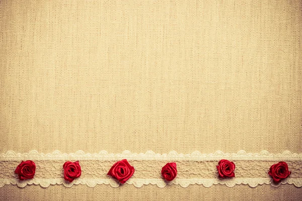 Red silk roses on cloth — Stock Photo, Image