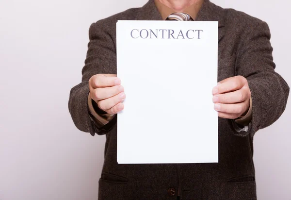 Businessman holding blank paper with sign contract — Stock Photo, Image