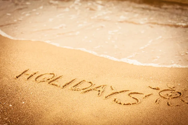 Na święta słowo napisane w piasku — Zdjęcie stockowe