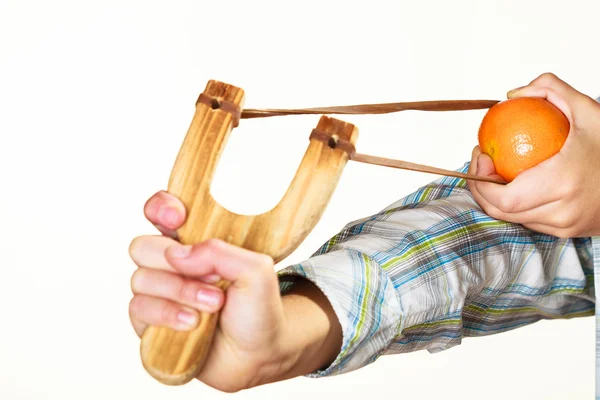 Kid holding slingshot in hands — Stock Photo, Image