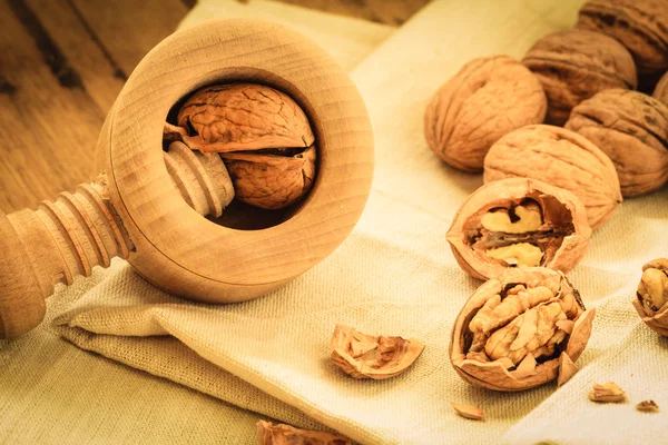 Nuez con cascanueces sobre mesa rústica — Foto de Stock