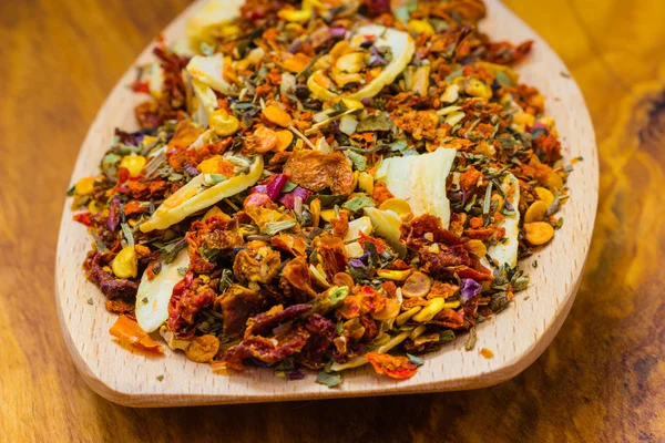 Colored spices for pasta mix on wooden spoon — Stock Photo, Image