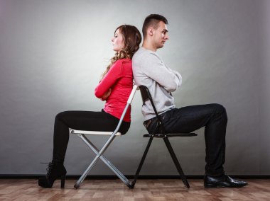 Couple after quarrel sitting on chairs clipart