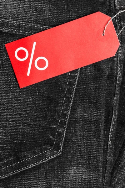 Label with percent sign on denim — Stock Photo, Image