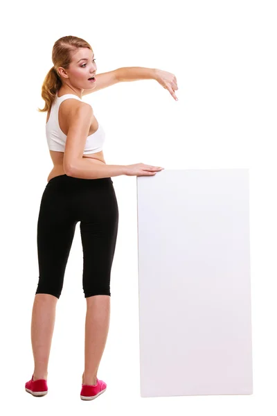 Sporty woman holding blank banner — Stock Photo, Image