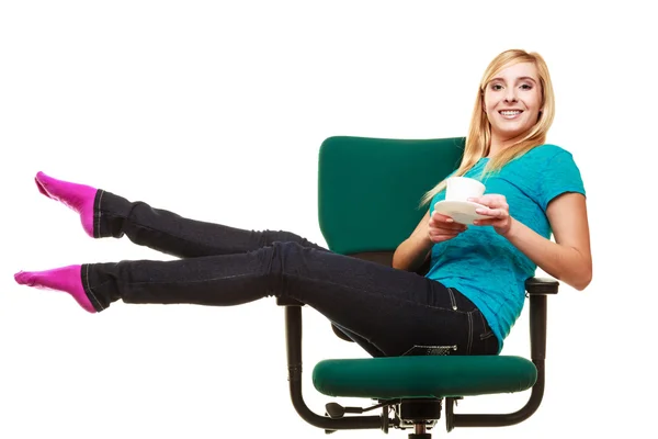 Chica sentada en silla relajante sostiene taza de té o café . — Foto de Stock