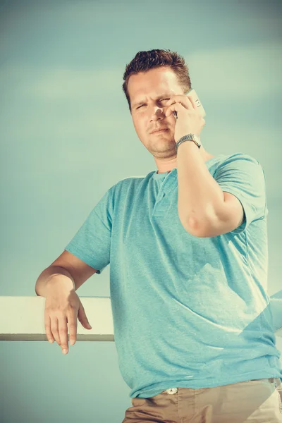 Man on pier using smartphone. — Stock Photo, Image