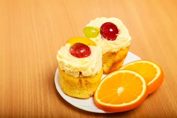 Torten und Orange auf Teller — Stockfoto
