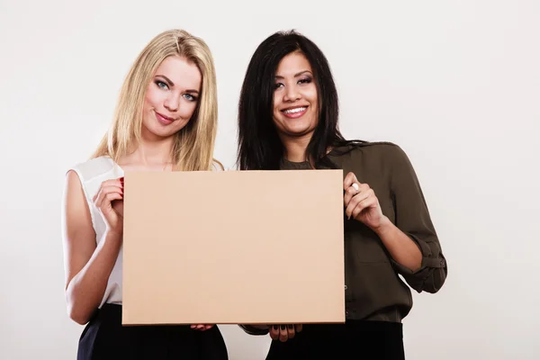Two women holding blank board — Stock Photo, Image