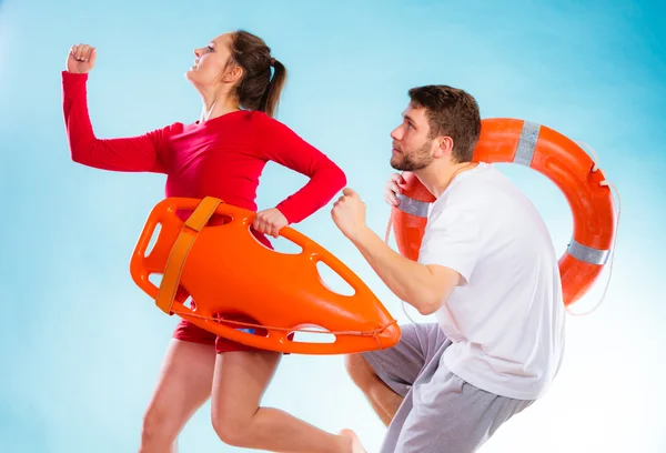 Lifeguards running with equipment — Stock Photo, Image