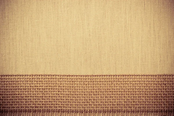 Jute ribbon on linen cloth background — Stock Photo, Image