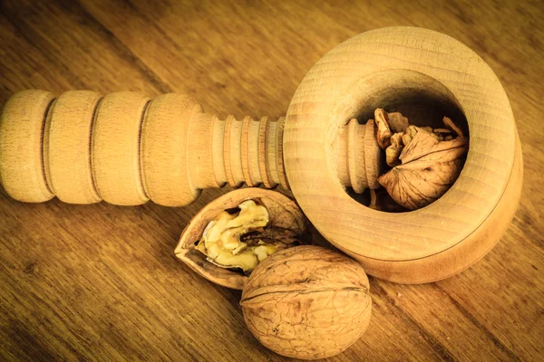 Walnuts and nutcracker on  table — Stock Photo, Image