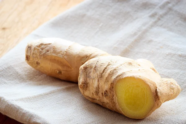 Closeup fresh raw ginger on rustic table — Stock Photo, Image