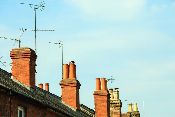 Roof tops and brick chimneys on houses — Stock Photo, Image