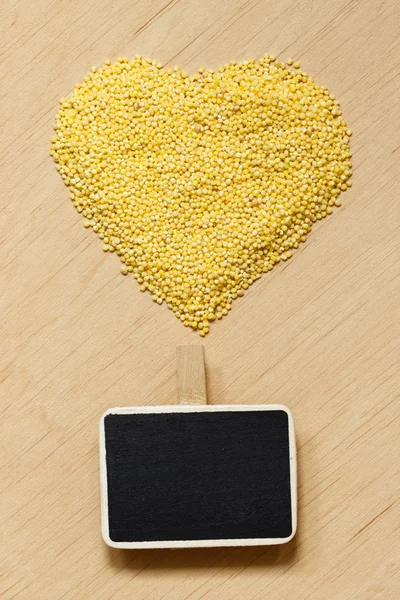 Millet groats heart shaped — Stock Photo, Image