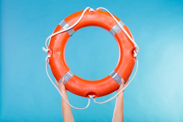 Life buoy ring in female hands — Stock Photo, Image