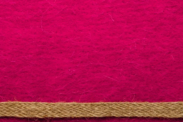 Jute touw over roze textiel — Stockfoto