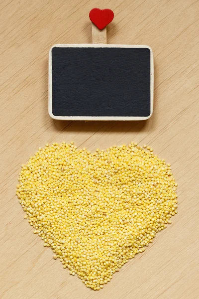 Millet groats heart shaped — Stock Photo, Image