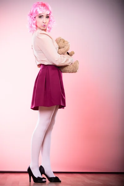 Childlike woman holding teddy bear toy — Stock Photo, Image