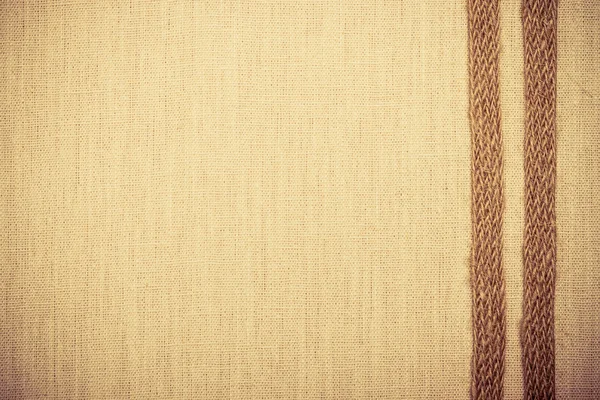 Jute ribbon on linen cloth — Stock Photo, Image