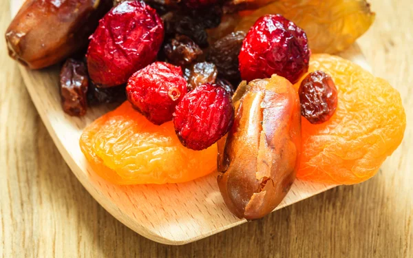 Dried fruit on wooden spoon. — Stock Photo, Image