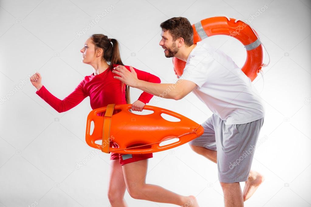 Lifeguards running with equipment Stock Photo by ©Voyagerix 77104383