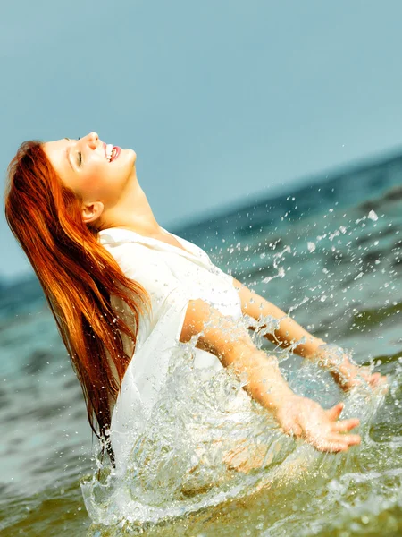 Vacation. Girl splashing water having fun on the sea. — Stock Photo, Image