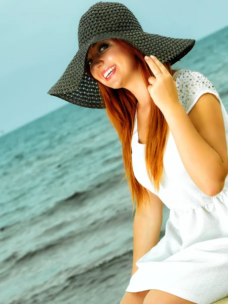 Beautiful redhaired girl in hat on beach, portrait — Stock Photo, Image