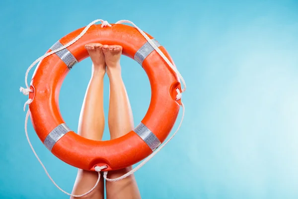 Life buoy ring on female legs — Stock Photo, Image