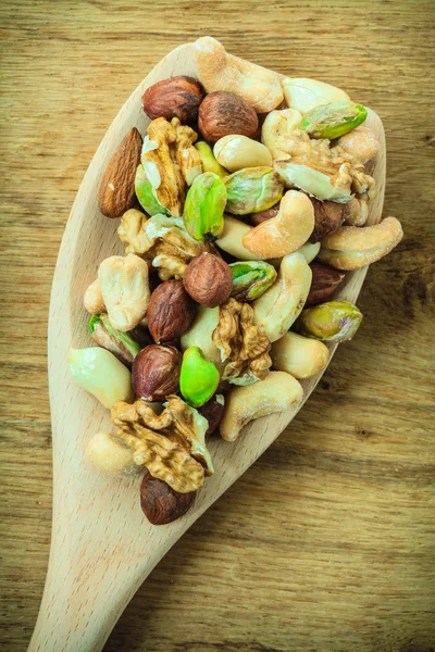 Nuts on wooden spoon. — Stock Photo, Image