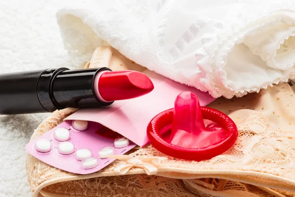 Pills condom and lipstick — Stock Photo, Image