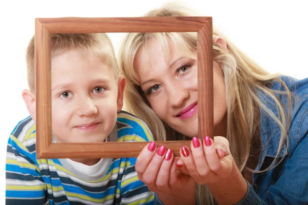 Portrait of mother and son holding photo frame — Stock Photo, Image