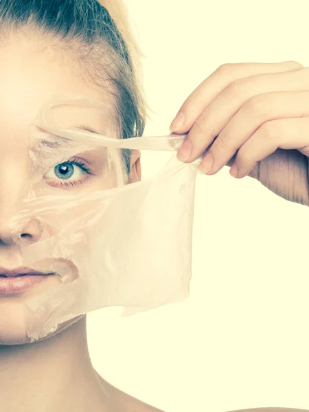 Girl removing facial peel off mask — Stock Photo, Image