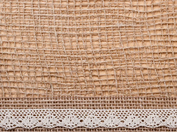 Ruban de dentelle sur toile de jute fond — Photo