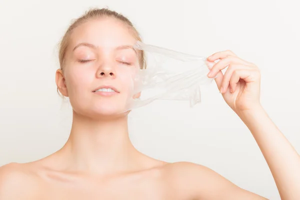 Girl removing facial peel off mask — Stock Photo, Image