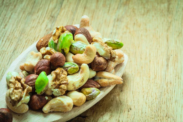 Nuts on wooden spoon. — Stock Photo, Image