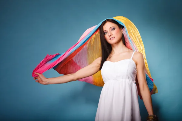 Woman holding  multicolored flying shawl — Stock Photo, Image