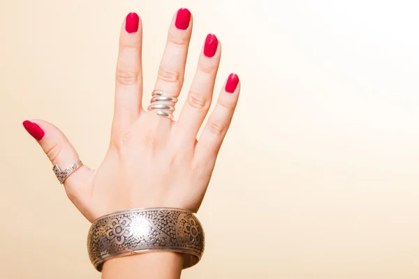 Female hand with manicure and armlet — Stock Photo, Image