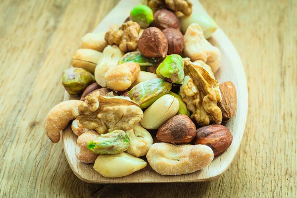 Mix of nuts on wooden spoon. — Stock Photo, Image