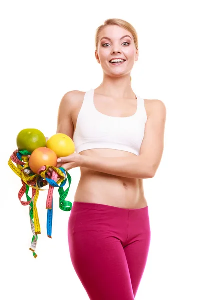 Happy woman holding grapefruits and tape measures. — Stock Photo, Image