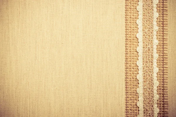 Cornice in pizzo su sfondo tela di lino — Foto Stock