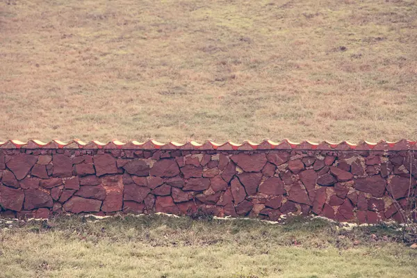 Stone fence on field. — Stock Photo, Image