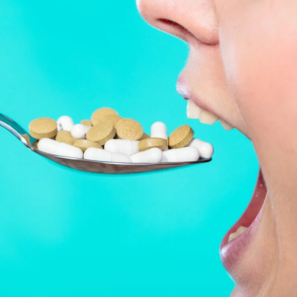 Woman eating pills — Stock Photo, Image