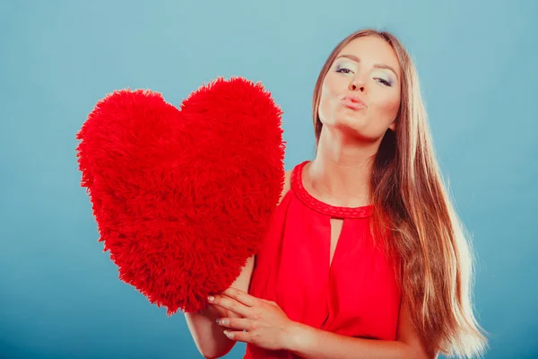 Vrouw met hart vorm kussen — Stockfoto