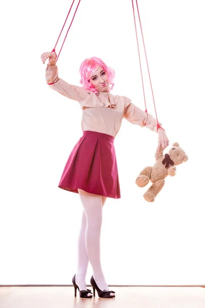 Woman marionette on strings with teddy bear — Stock fotografie