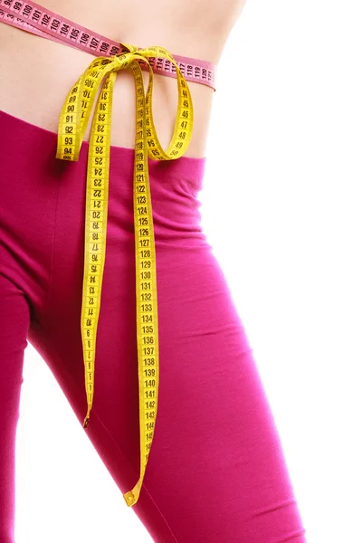 Woman measuring waist with tape measure. — Stock Photo, Image