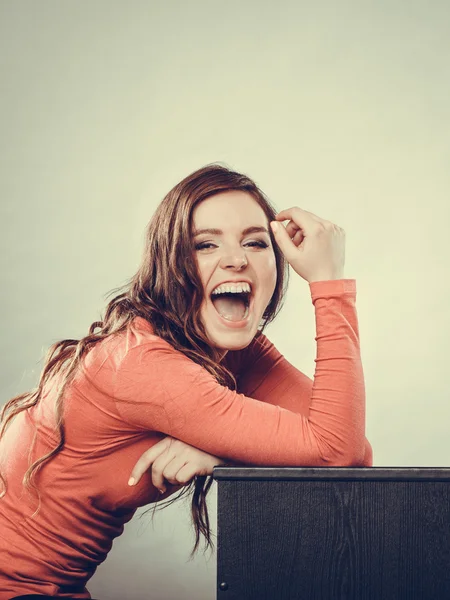 L laughing woman sitting at home. — Stockfoto