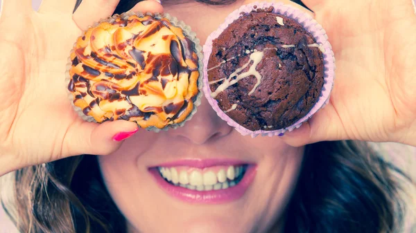 Woman having fun holding cakes — Stock Photo, Image