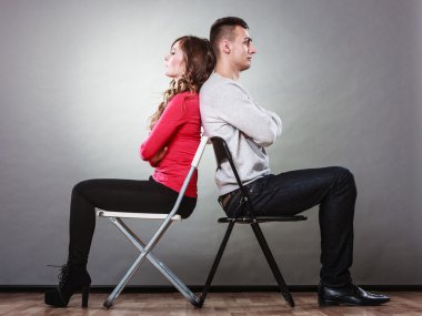 Young couple after quarrel sitting back to back clipart